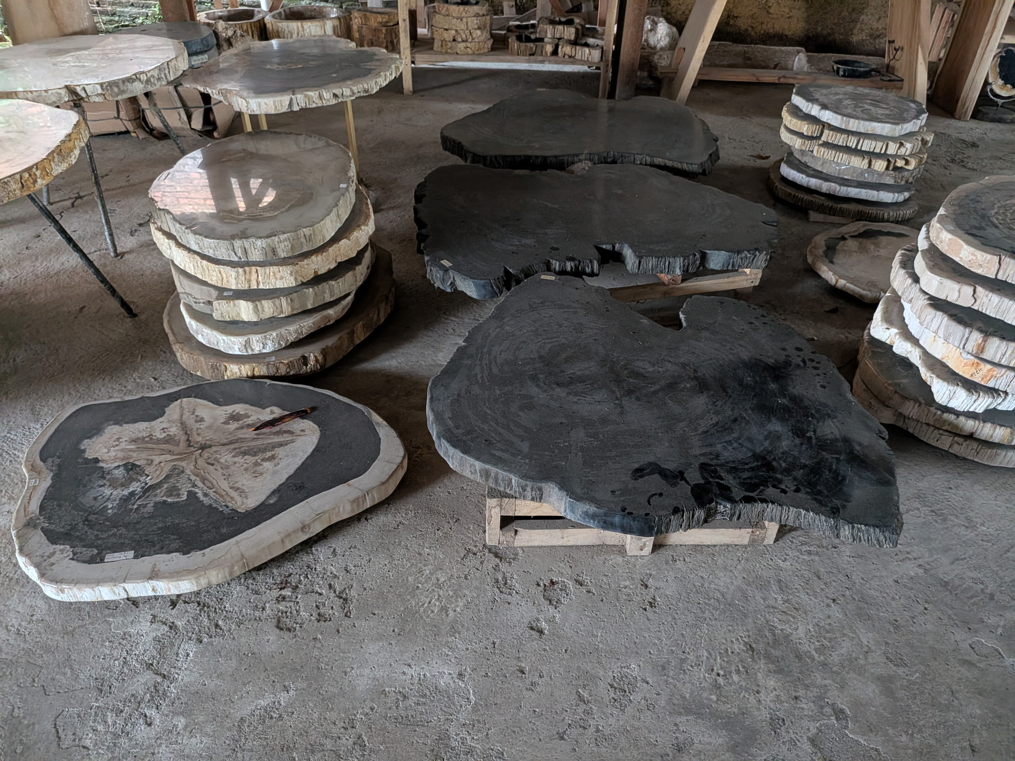 Stacked petrified wood slabs of varying size at the Java yard.